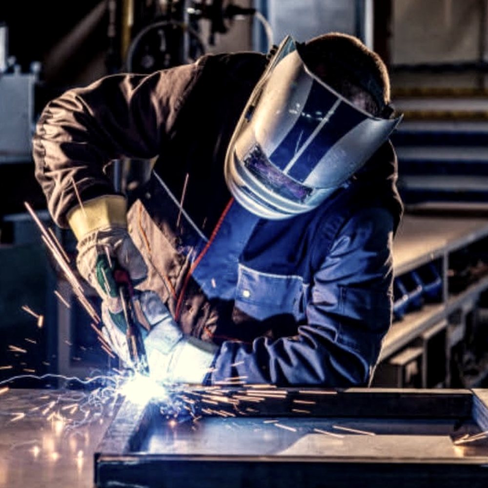 Laying a weld on a steel frame in the shop